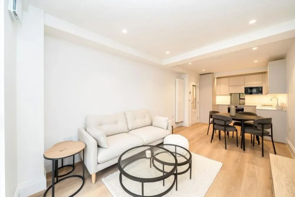 Living room opening into a kitchen and dining area