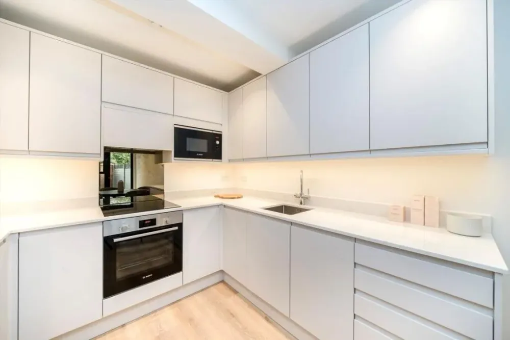 White kitchen with built-in oven and microwave