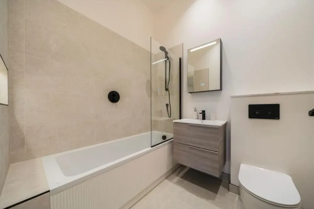 Bathroom with a bath, glass screen and wall-hung vanity