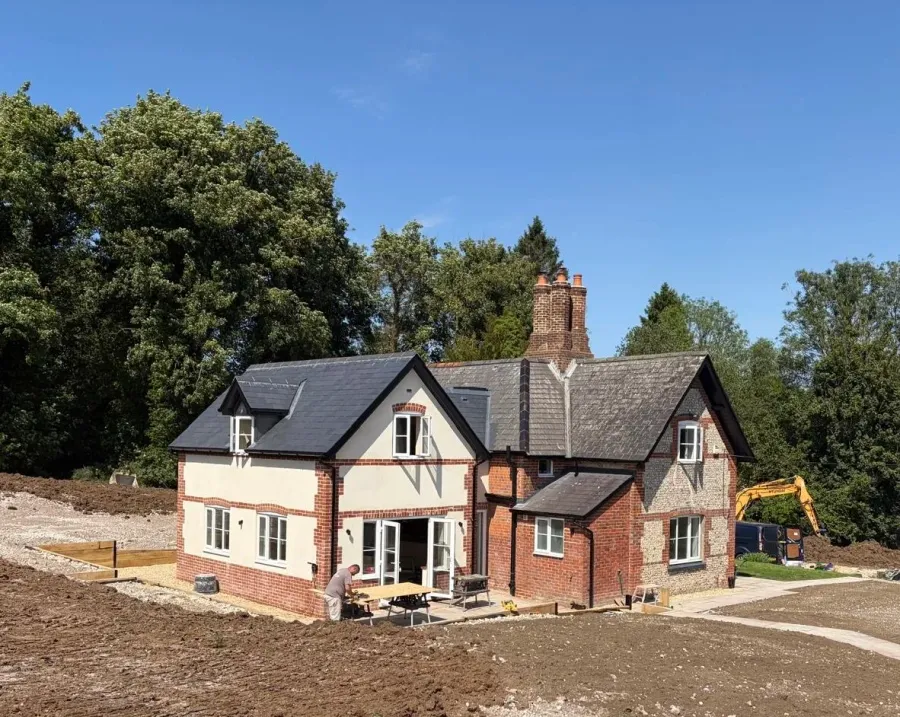 Parkland Lodge, Hampshire: a brick and flint lodge with its new extension built and the garden being made