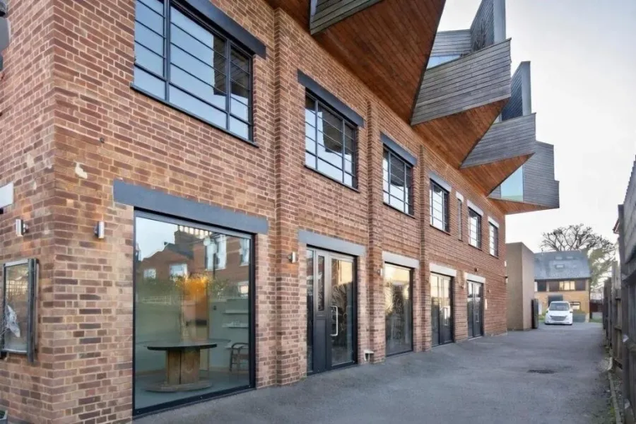 The Talent Factory: a brick and black-clad building with large factory-style windows